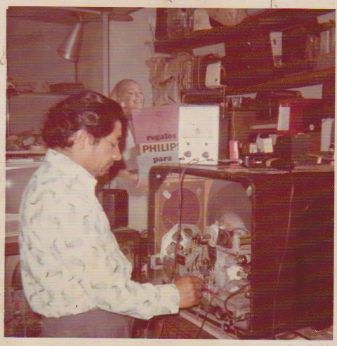 Papito, Javier and Manuel's grandfather, repairing electronics at his shop in Lima, Peru
